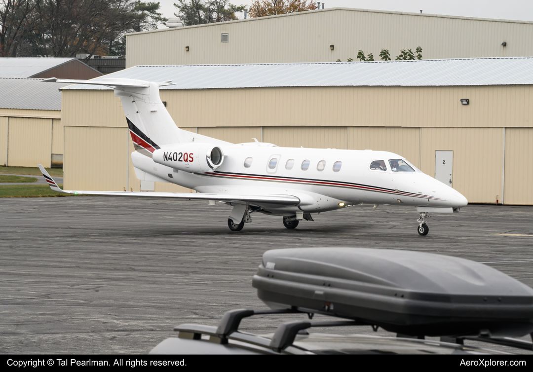 Photo of N402QS - NetJets Embraer Phenom 300 at GAI on AeroXplorer Aviation Database