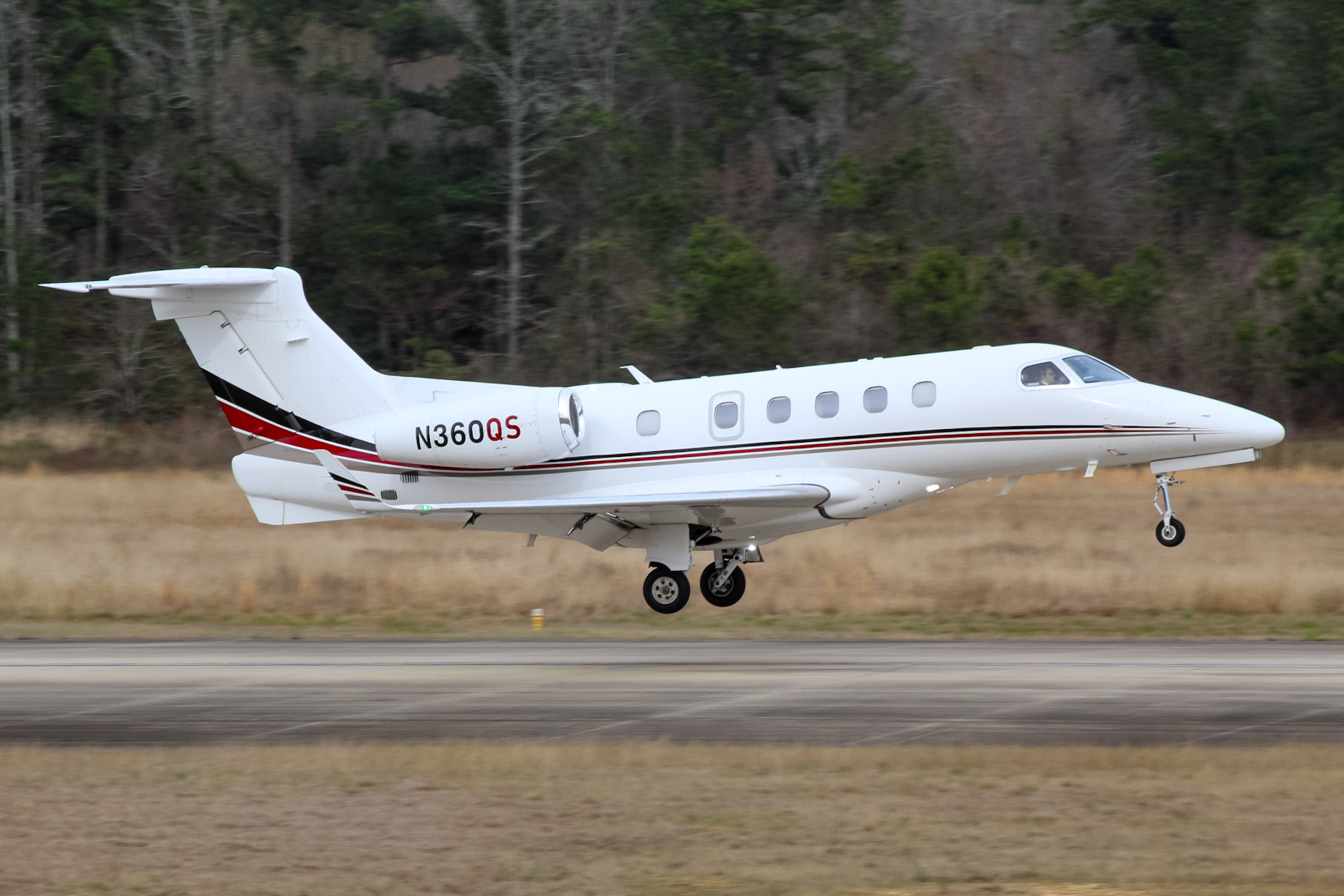 Full size: NetJets Embraer Phenom 300 N360QS at Conroe Lone Star Executive Airport