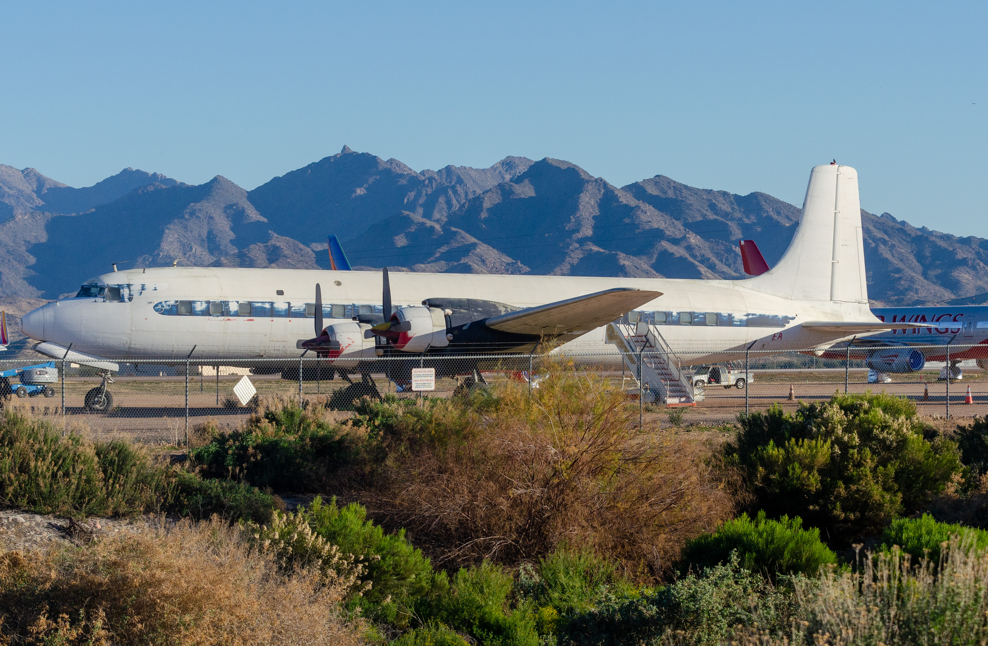 Full size: PRIVATE Douglas DC-7 N777EA at Phoenix Goodyear Airport